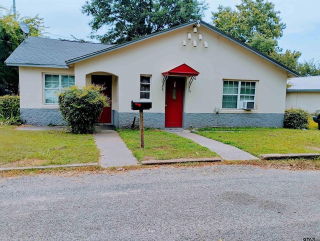 view of front of home with cooling unit and a front lawn