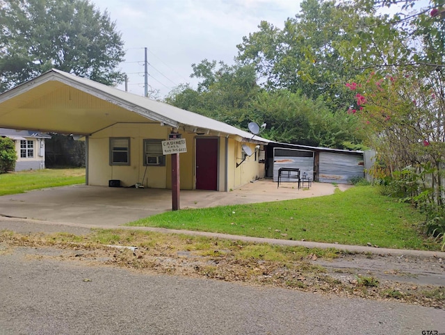 view of parking featuring a yard and a carport