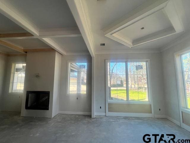 unfurnished living room featuring beam ceiling, coffered ceiling, ornamental molding, and concrete flooring