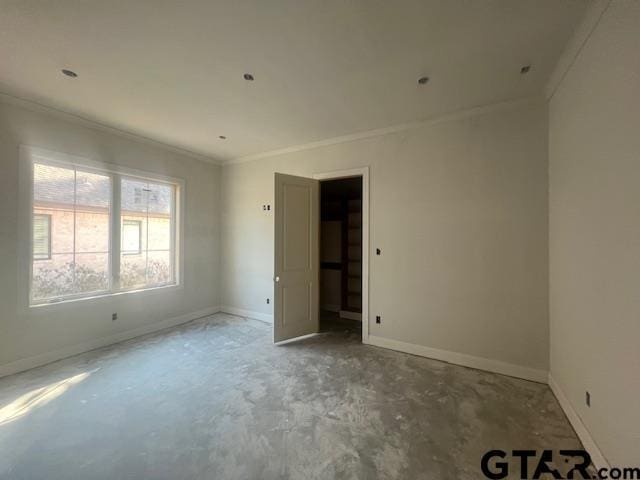 empty room featuring crown molding