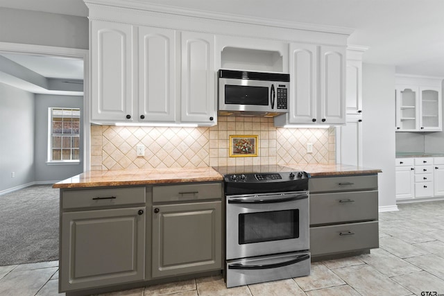 kitchen with stainless steel appliances, gray cabinets, white cabinets, and tasteful backsplash