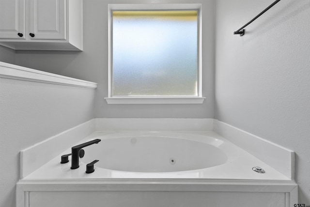 bathroom with a washtub and a wealth of natural light