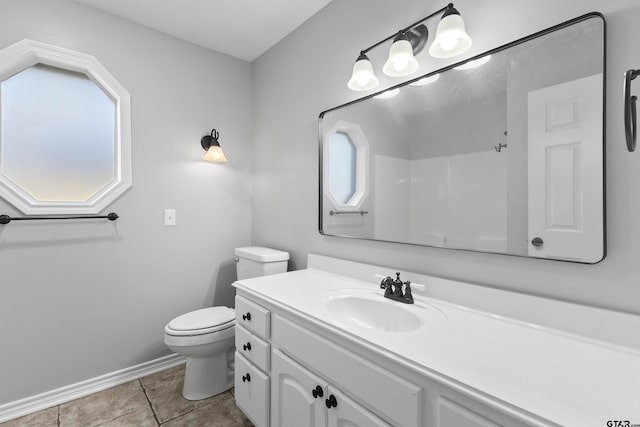 bathroom featuring toilet, vanity, tile patterned flooring, and walk in shower