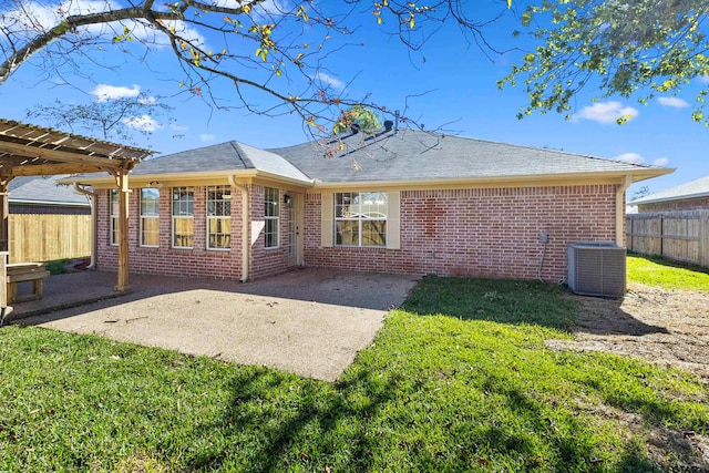 rear view of property featuring central air condition unit, a yard, and a patio area