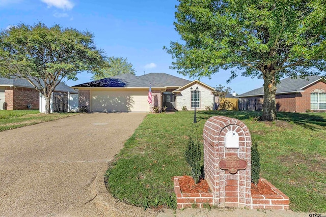 ranch-style home featuring a garage and a front yard