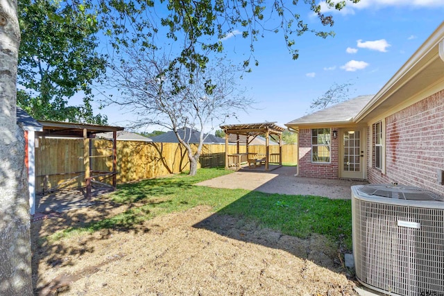 view of yard with central AC unit, a patio, and a pergola