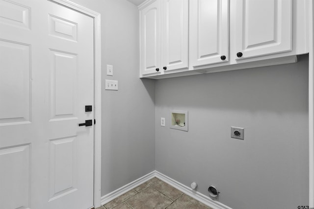 laundry room with hookup for an electric dryer, hookup for a washing machine, cabinets, and tile patterned floors