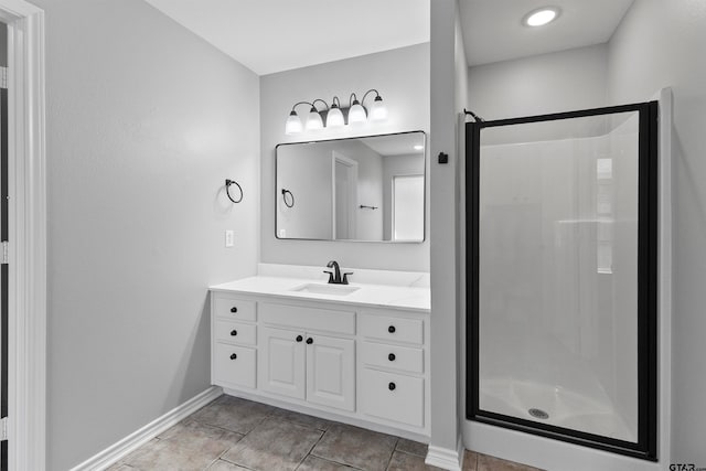 bathroom with tile patterned floors, vanity, and a shower with door