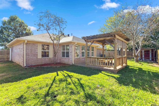 rear view of house with a deck, a lawn, a storage shed, and a pergola