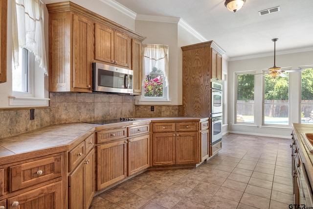 22886 County Road 422, Lindale, TX 75771 - kitchen featuring appliances with stainless steel finishes, a ceiling fan, decorative backsplash, ornamental molding, and hanging light fixtures