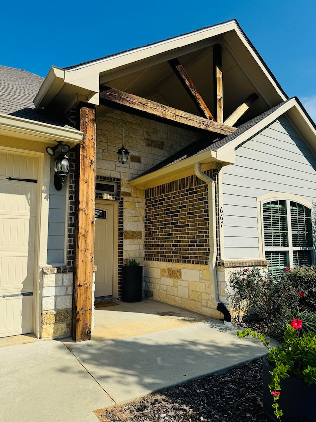 doorway to property with a garage