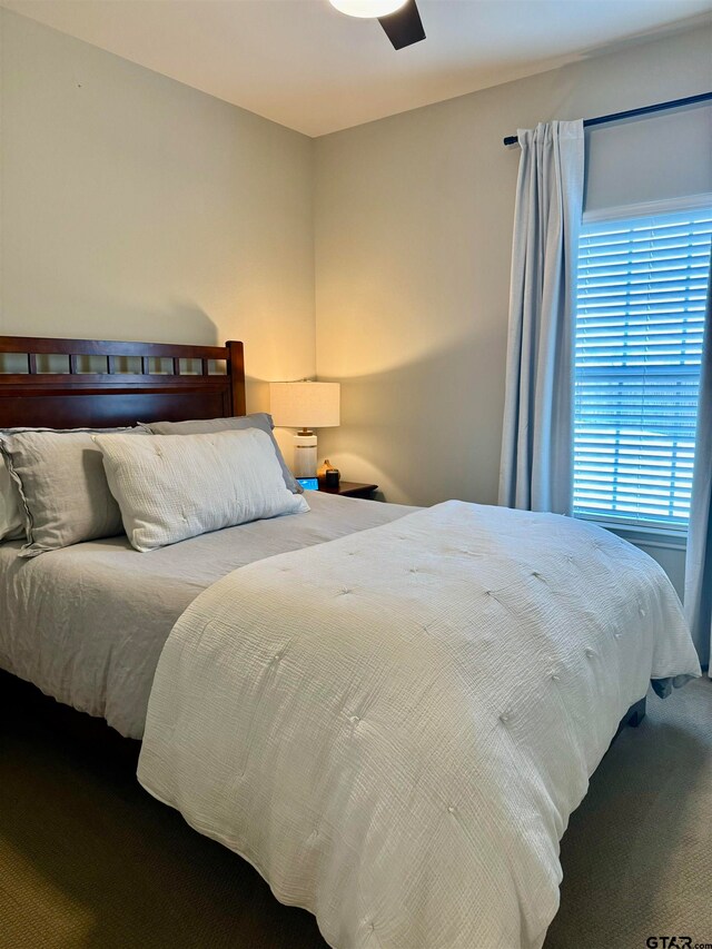 carpeted bedroom featuring ceiling fan