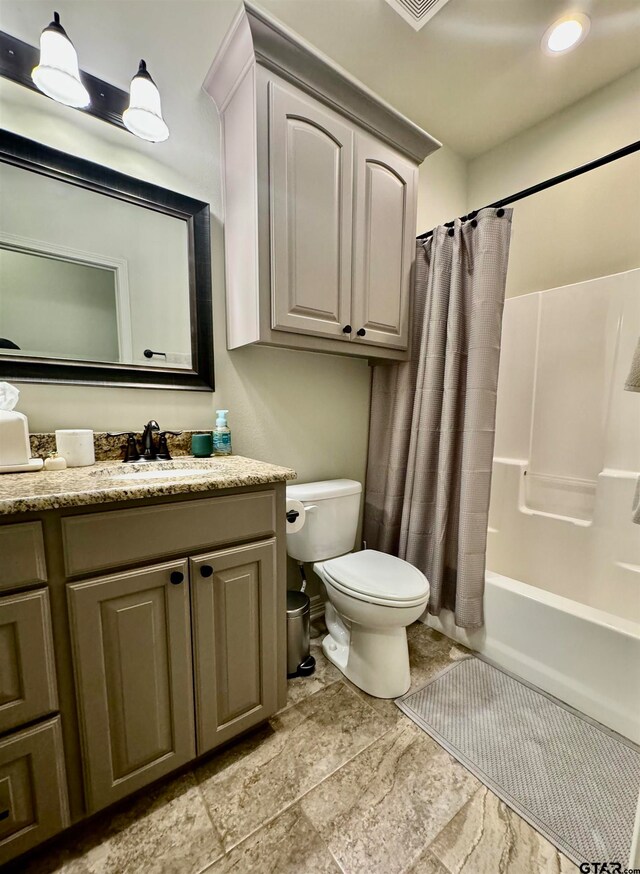 full bathroom with shower / bath combo with shower curtain, vanity, and toilet