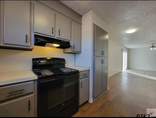 2A Robin Dr, Texarkana, TX 75503 - kitchen featuring under cabinet range hood, black electric range, gray cabinetry, a textured ceiling, and light countertops