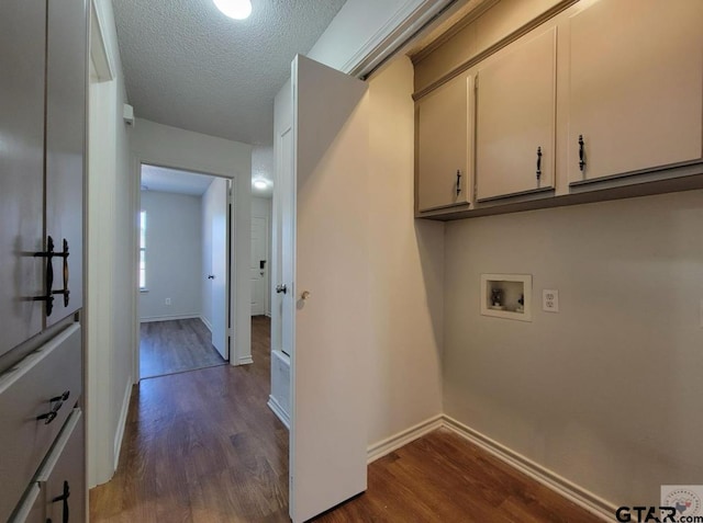 2A Robin Dr, Texarkana, TX 75503 - laundry room featuring washer hookup, dark wood finished floors, cabinet space, and a textured ceiling