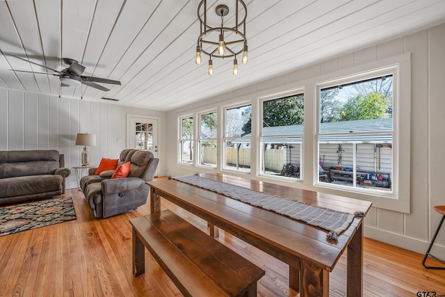 dining space featuring light wood finished floors and wooden ceiling