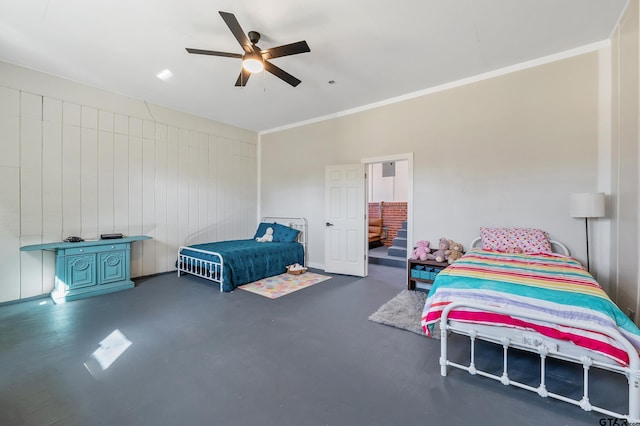 bedroom featuring ornamental molding, concrete floors, and ceiling fan