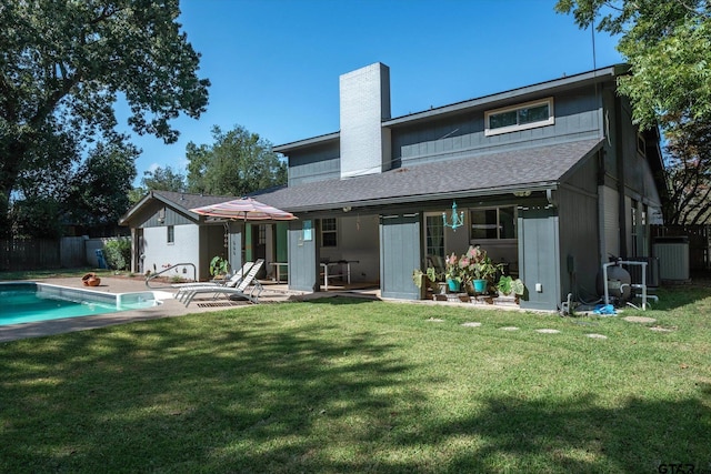 924 Bradley Dr, Athens, TX 75751 - back of house featuring a chimney, a lawn, a fenced in pool, fence, and a patio area