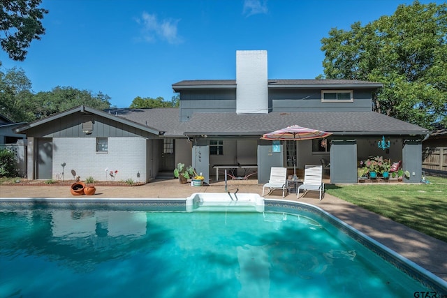924 Bradley Dr, Athens, TX 75751 - rear view of property featuring a patio area, roof with shingles, a chimney, and a fenced in pool