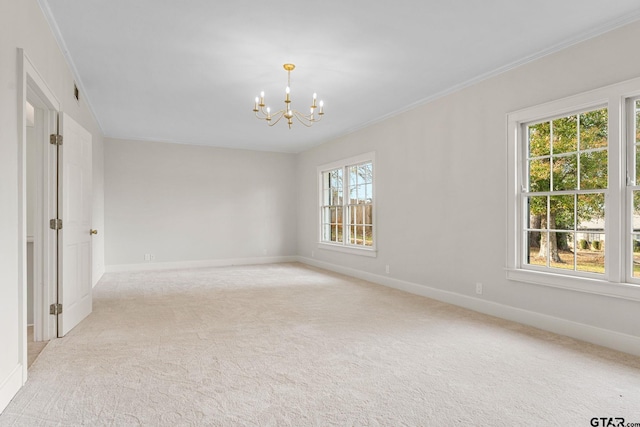 empty room with crown molding, light colored carpet, and a notable chandelier