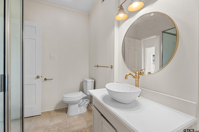 bathroom with crown molding, vanity, and toilet