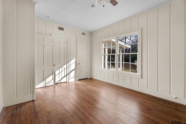 spare room featuring wood-type flooring and ceiling fan