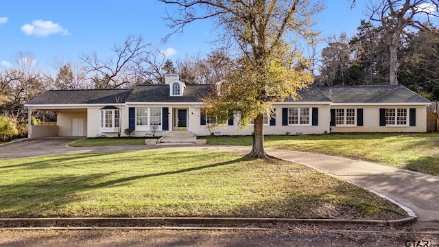 single story home featuring a front lawn and a carport