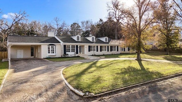 view of front of home with a front yard and a carport