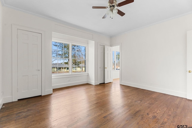 spare room featuring crown molding, dark hardwood / wood-style floors, and ceiling fan