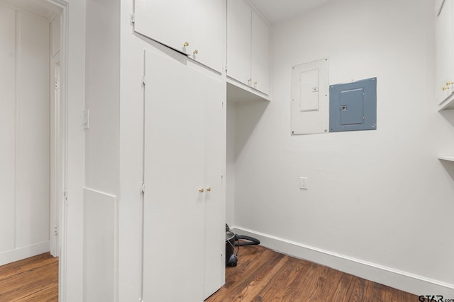 laundry room featuring dark wood-type flooring and electric panel