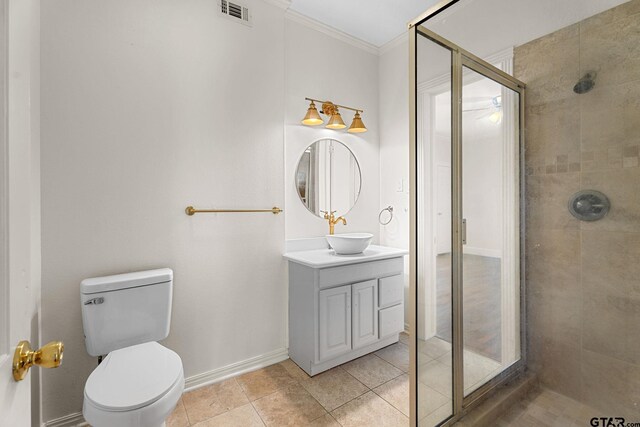 bathroom with vanity, walk in shower, toilet, crown molding, and tile patterned floors