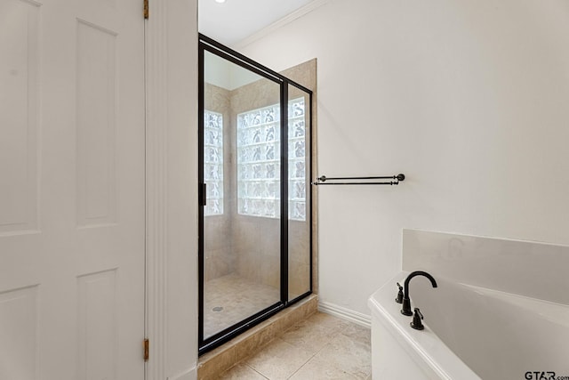 bathroom featuring tile patterned flooring, crown molding, and shower with separate bathtub