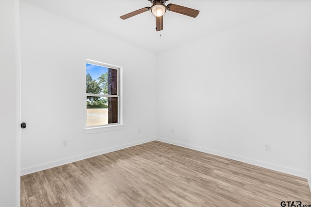 unfurnished room featuring baseboards, ceiling fan, and light wood finished floors