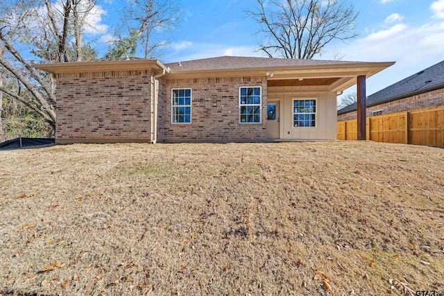 back of property featuring a lawn