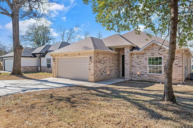 view of front of property featuring a garage and a front lawn