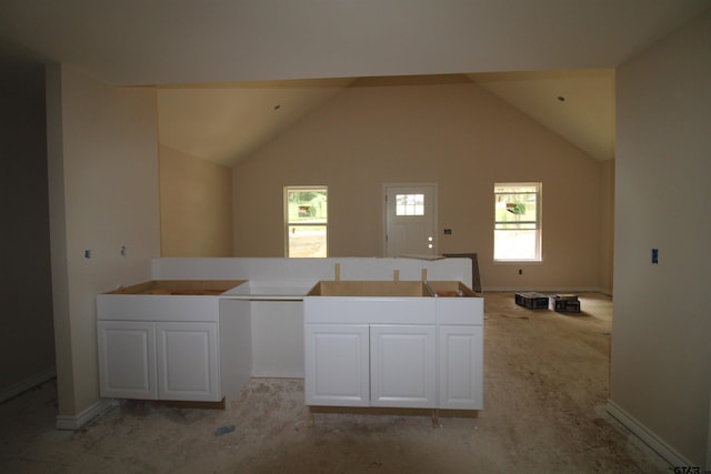 16954 Deer Run Rd, Flint, TX 75762 - kitchen featuring white cabinetry, open floor plan, light colored carpet, and vaulted ceiling