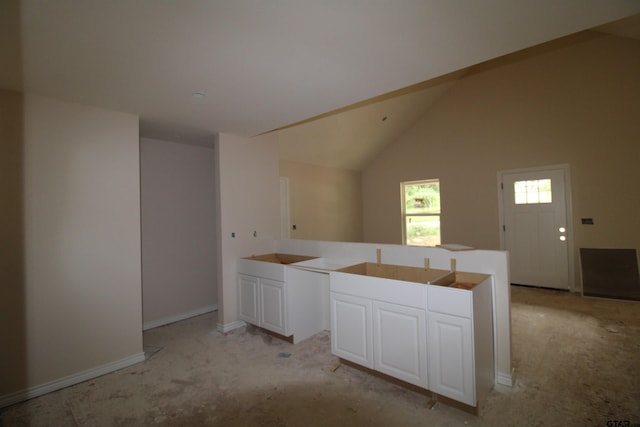 16954 Deer Run Rd, Flint, TX 75762 - kitchen featuring light colored carpet, white cabinets, and lofted ceiling