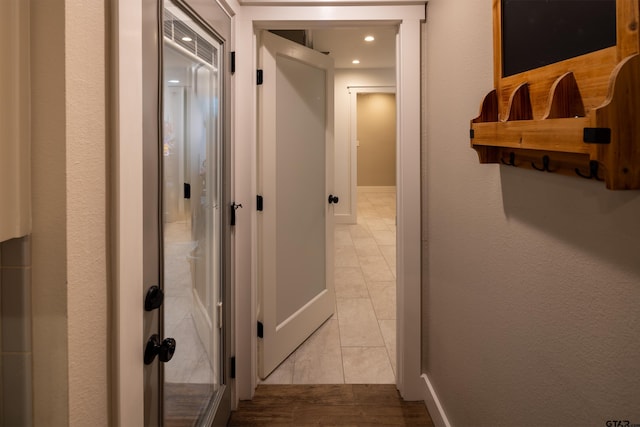 hallway featuring light tile patterned floors