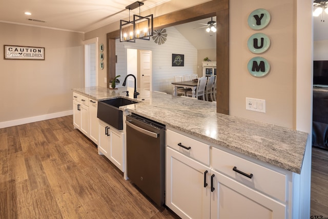 kitchen with sink, white cabinetry, light stone counters, decorative light fixtures, and stainless steel dishwasher