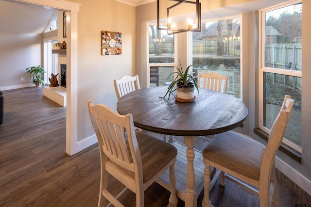 dining room featuring plenty of natural light, dark hardwood / wood-style floors, and a notable chandelier