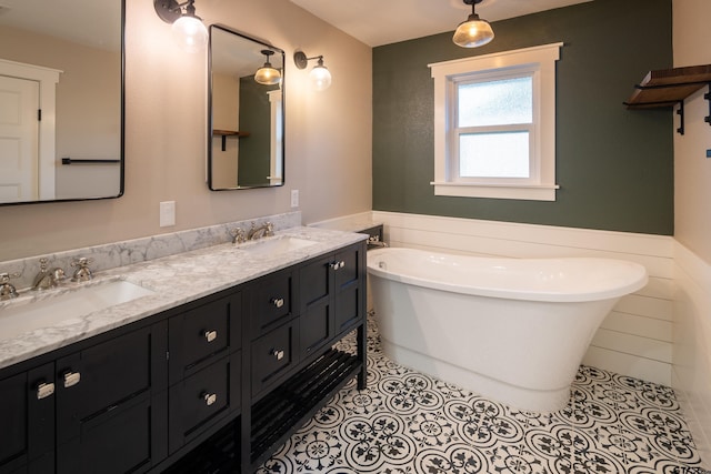 bathroom with vanity, tile patterned floors, and a tub to relax in