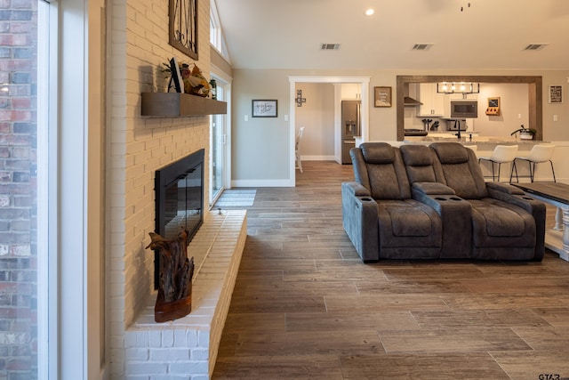 living room with a brick fireplace