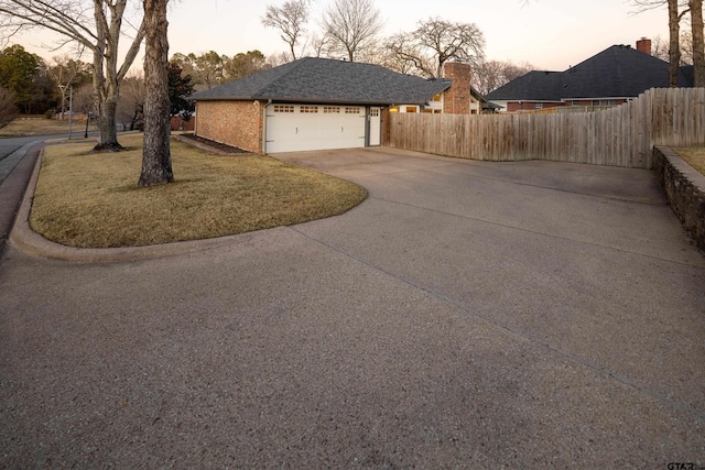 property exterior at dusk featuring a garage