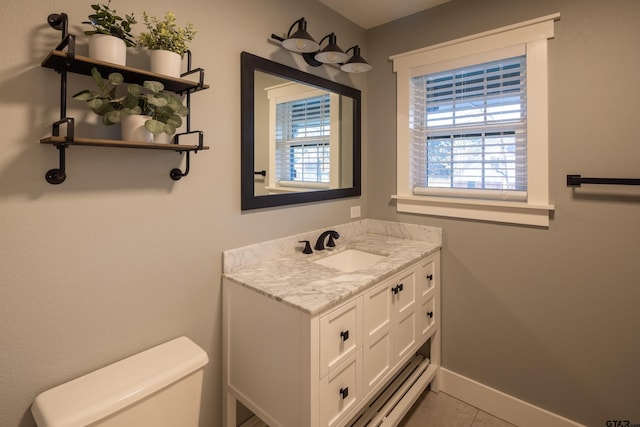 bathroom with vanity, tile patterned flooring, and toilet