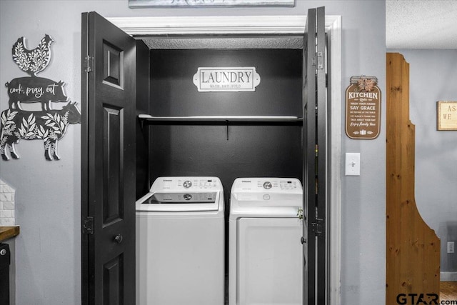 12305 Pine St, Larue, TX 75770 - laundry area featuring washing machine and dryer, a textured ceiling, and laundry area