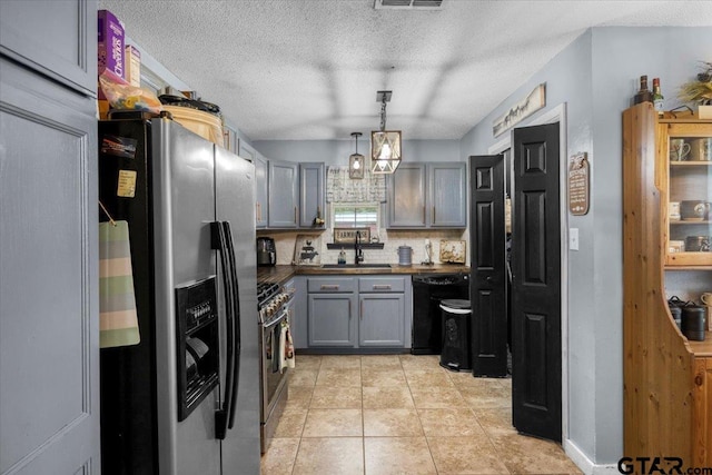 12305 Pine St, Larue, TX 75770 - kitchen with stainless steel appliances, dark countertops, decorative backsplash, gray cabinetry, and a textured ceiling
