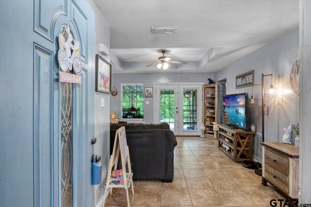 12305 Pine St, Larue, TX 75770 - living area with a ceiling fan, a textured ceiling, french doors, a raised ceiling, and visible vents