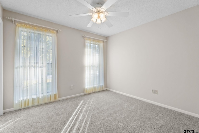 unfurnished room with carpet flooring, ceiling fan, and a textured ceiling