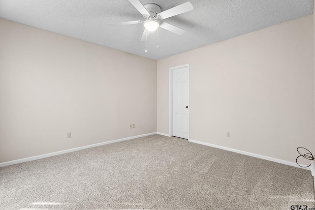 carpeted empty room featuring ceiling fan and a textured ceiling