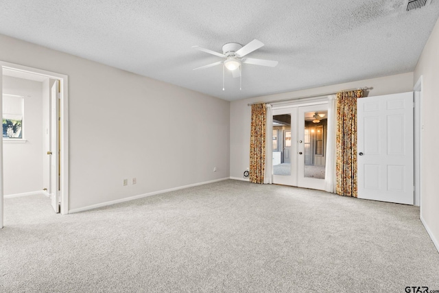 unfurnished room with light carpet, french doors, a textured ceiling, and ceiling fan